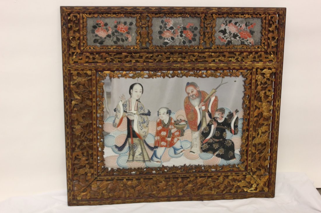 Chinese 19th century reverse painted glass panel: Beautiful Chinese 19th century reverse painted glass panel depicting Daoism gods, accented by small painted floral glass panels, enclosed in original carved gilt wood frame with floral motif in reticu