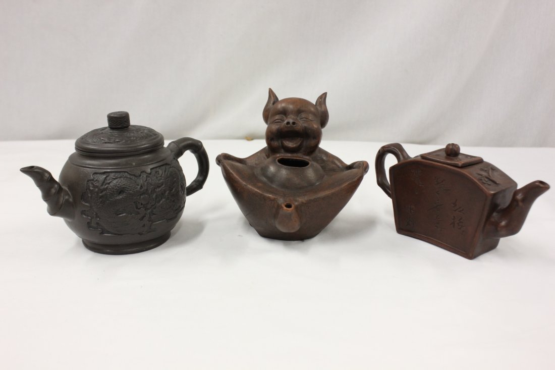 3 Chinese Yixing clay teapots: 3 Chinese Yixing clay teapots (5.1"Hx8.25"x5", 4"x7.7'x2"), with one in unusual form of pig (top missing) (5.7"x6.2"x6"