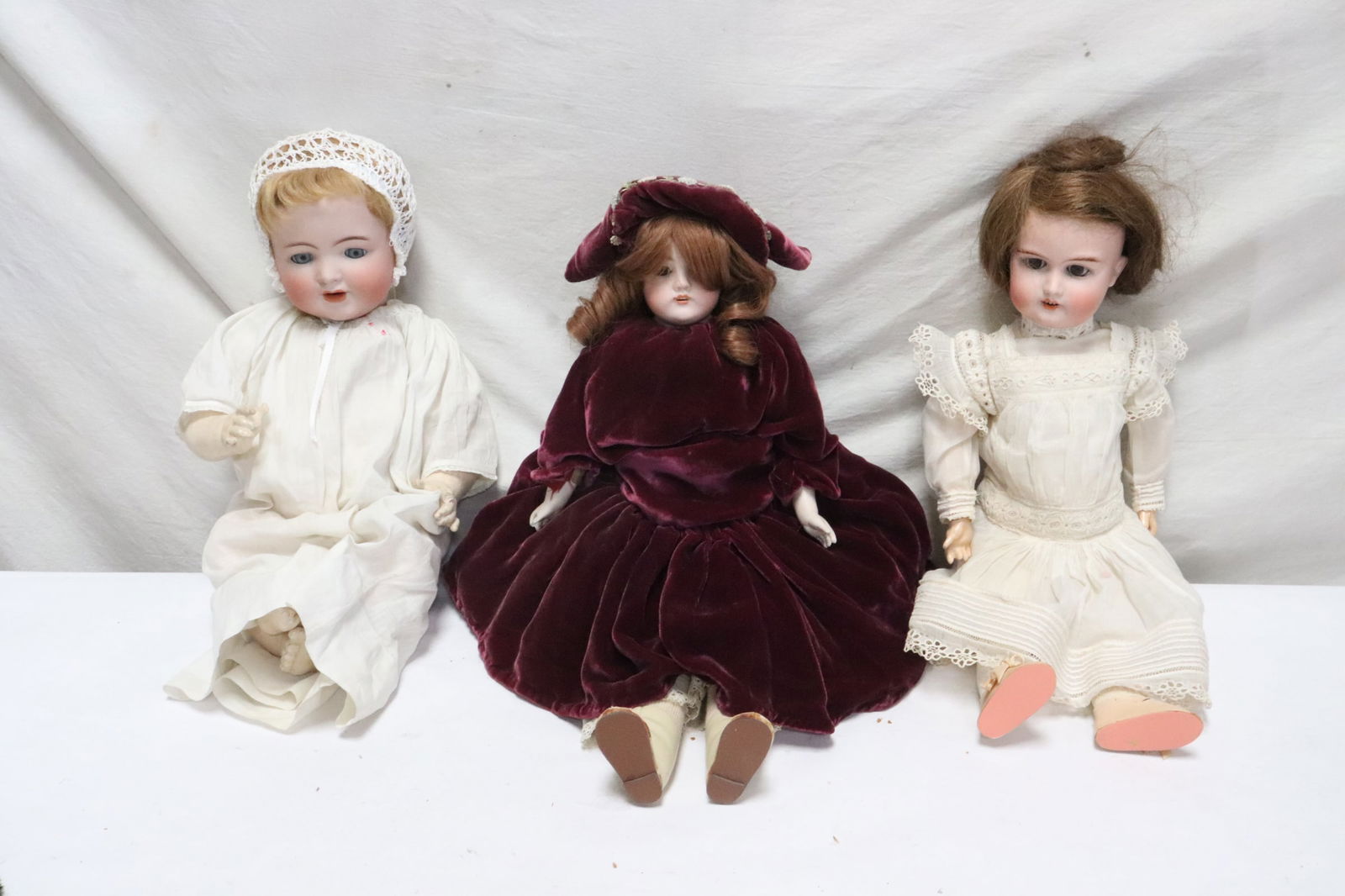 3 antique German bisque head dolls: 3 antique German bisque head dolls (20.2"H - 21.2"H); Majestic, Kammer and Reinhardt girl doll, and a DEP 154 doll