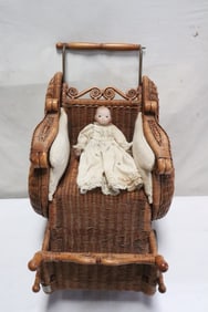 Antique German bisque head doll, & a wicker doll buggy