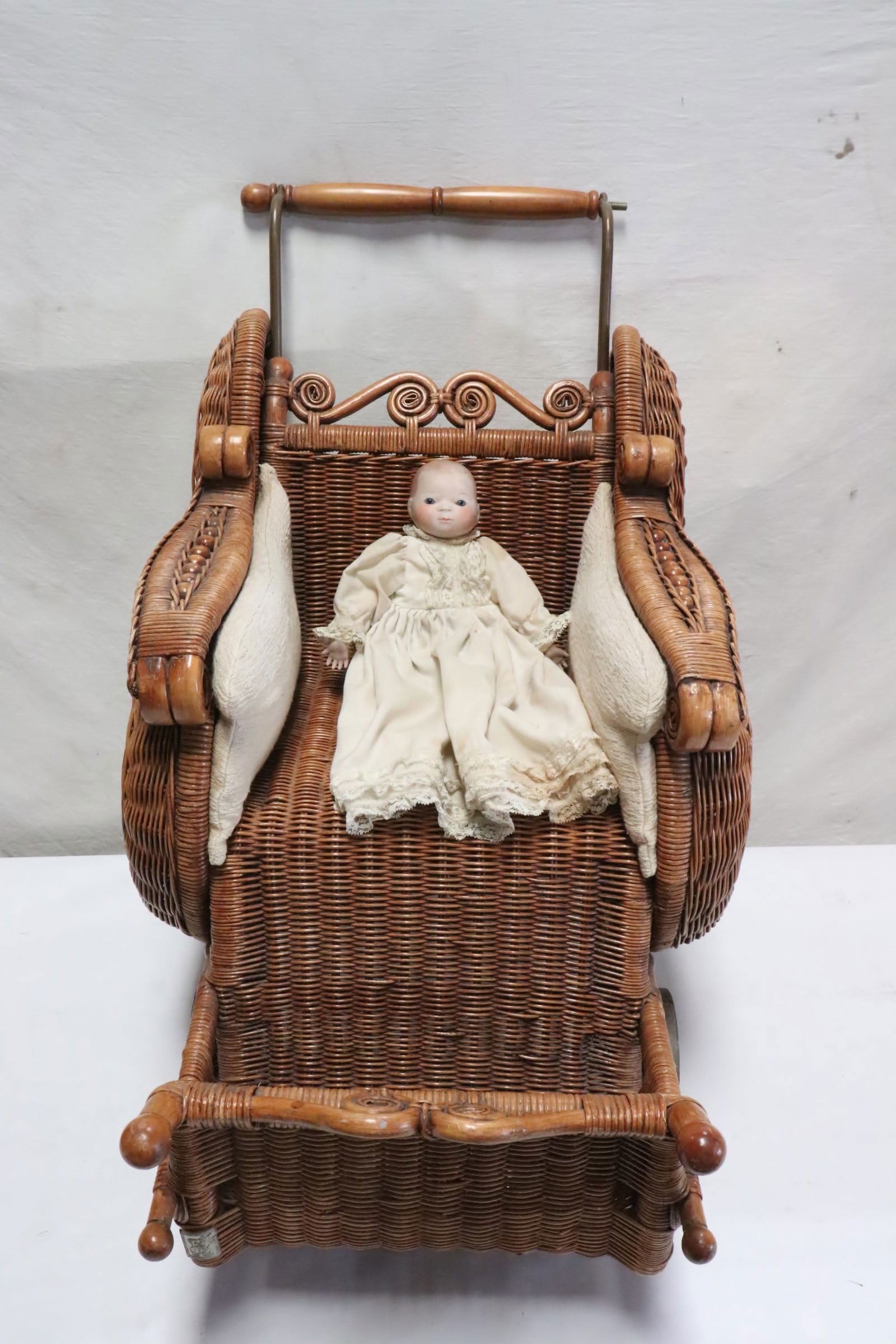 Antique German bisque head doll, & a wicker doll buggy (1 of 8)