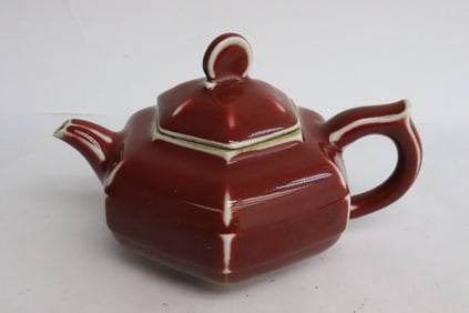 A red glazed porcelain teapot