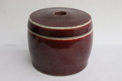 A red glazed porcelain tea caddy