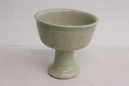 A white glazed crackleware stem bowl