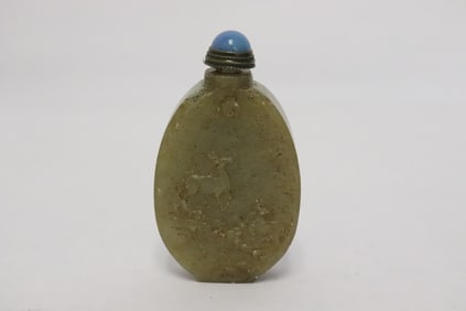 A jade like stone carved snuff bottle