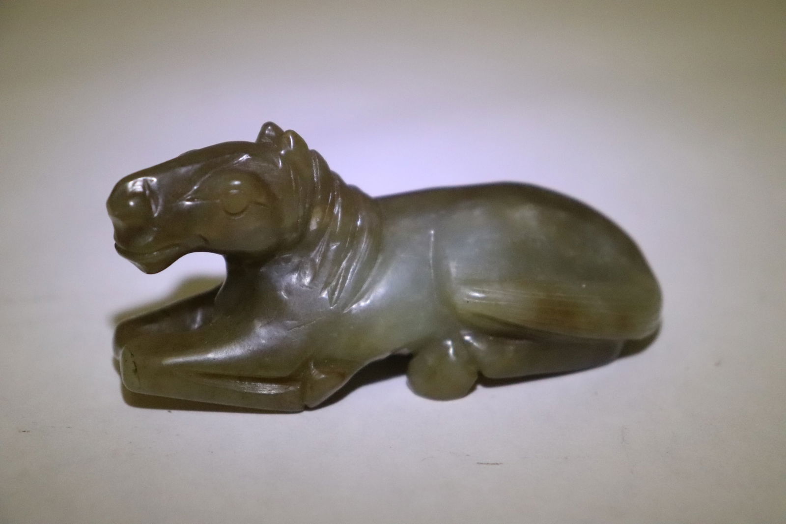 A celadon jade carved horse: A celadon jade carved horse, 1.4"x2.9"x1.15"