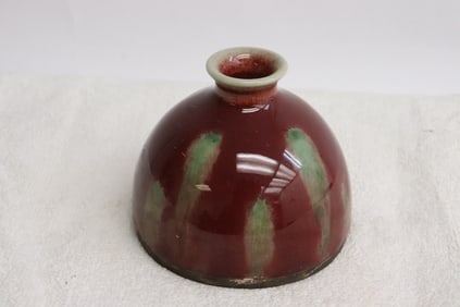 A green on red porcelain water dripper
