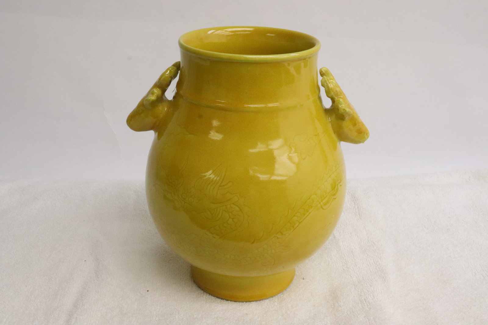 Yellow glazed porcelain jar: Yellow glazed porcelain jar with deer motif handles, 7.3"x6.65"x5.8"