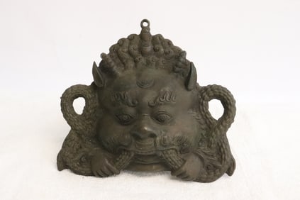 A bronze sculpture of mask