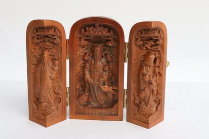 A wood like 3-panel shrine with deities