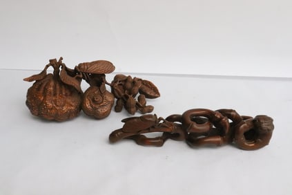 2 piece wood like fragments depicting fruit with bug