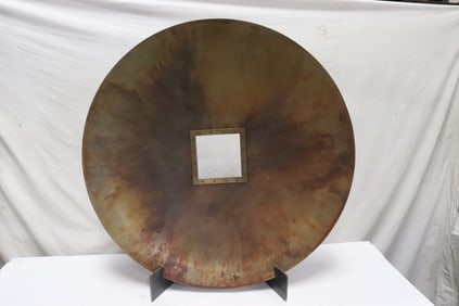 A massive modern bronze disc