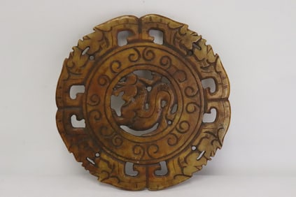 A jade like stone carved round plaque