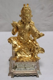 A gilt cast metal sculpture of deity