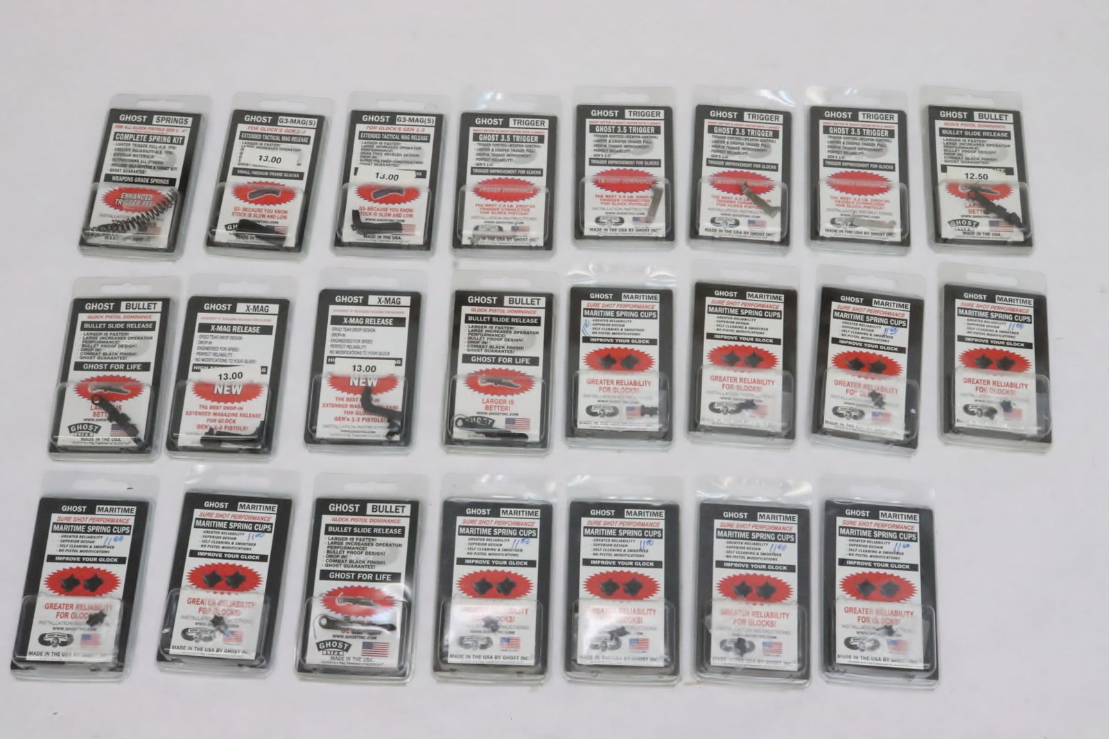 Lot of gun accessories by Ghost: 10 Maritime spring cups, 4 X-Mag. release, 4 Ghost 3.5 trigger, 4 bullet slide release, and a spring kit by Ghost