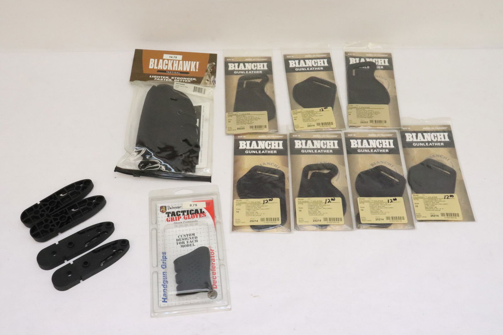 Lot of gun/ rifle accessories: 7 Bianchi gun leather, a tactical grip glove, a FRS-15 Gen III LOP spacer kit, and 2 Blackhawk tactical cheek pad for rifle
