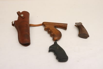 3 gun grips, and a leather pistol holster