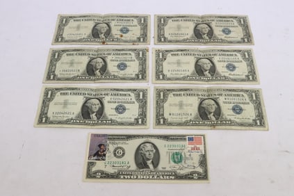 Six 1957 $1 silver certificates, and a 1976 $2 silver certificate