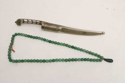 a jadeite like bead necklace, and a knife