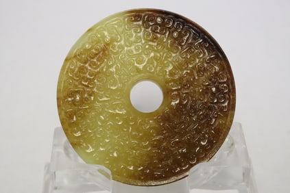 A jade like stone carved disc
