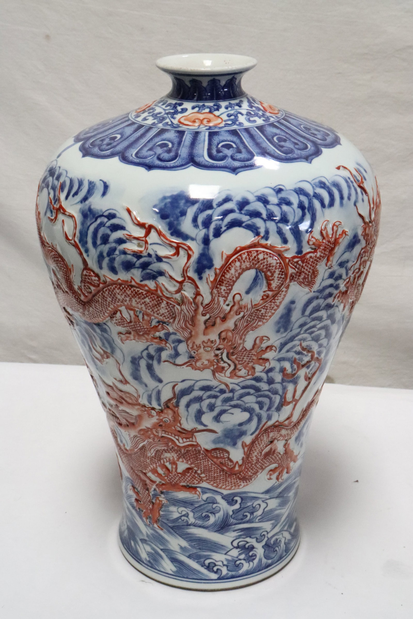 Chinese blue, red and white porcelain meiping: Chinese blue, red and white porcelain meiping with dragon motif decoration in relief, 14.8"x9.4"dia