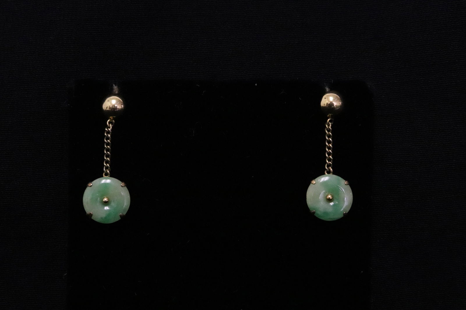 Pair Chinese 14K Y/G jadeite earrings: Pair Chinese 14K Y/G earrings set with apple green jadeite disc (~9.5mm diameter ea), total wt. 2.6gm