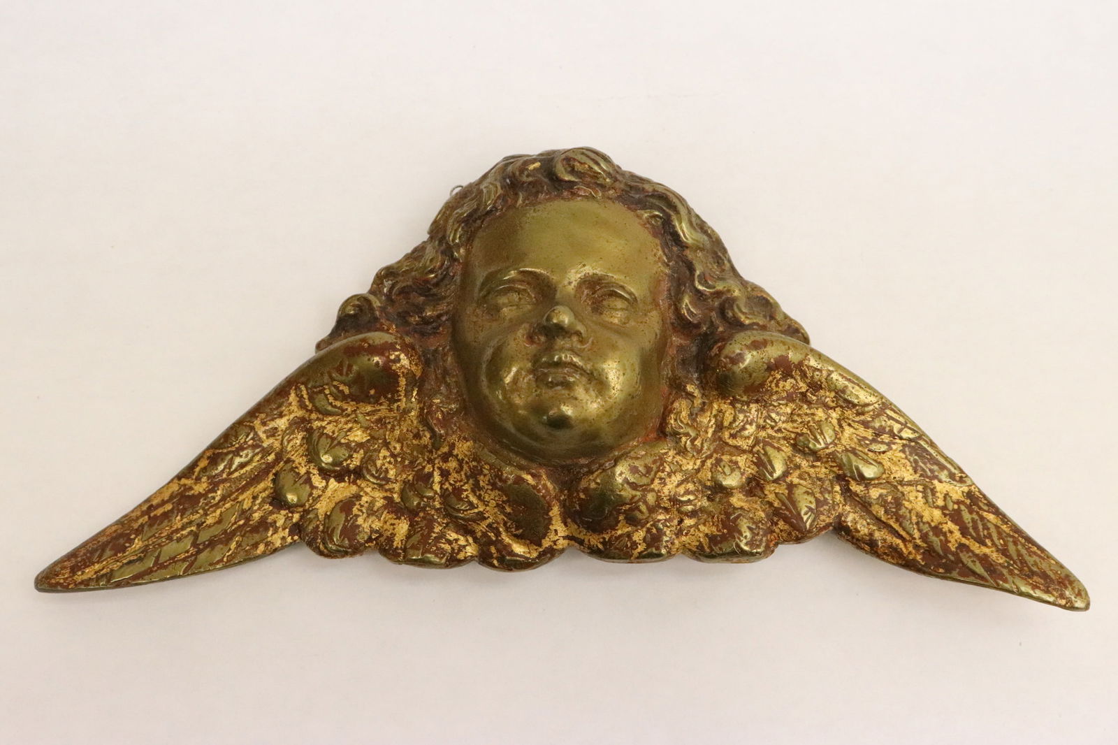 Antique French gilt bronze wall mounting ornament: Antique French gilt bronze wall mounting ornament in angel motif, 3.3"x7.35"x1.45"