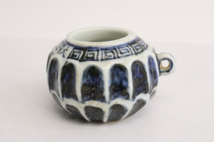 A blue and white porcelain bird feeder