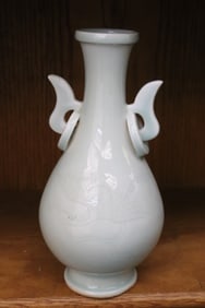 A celadon handled porcelain vase