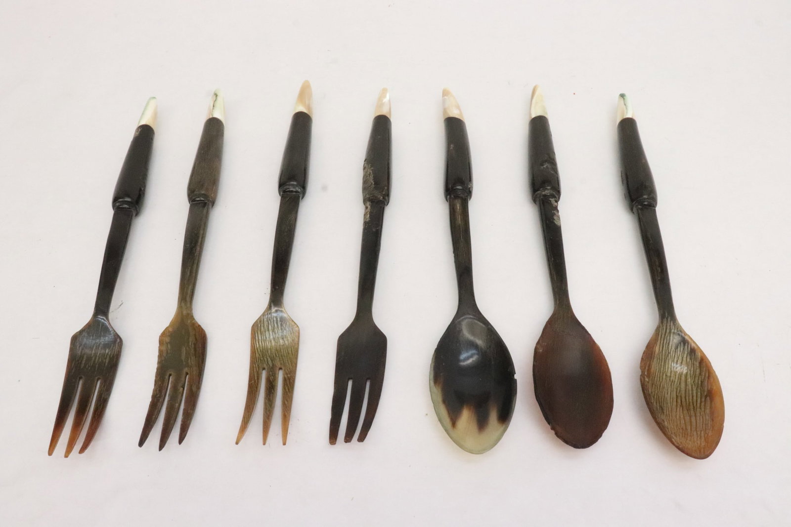 7 horn carved utensils with mother of pearl tip: 7 horn carved utensils with mother of pearl tip, chip, 11.35"L - 11.8"L