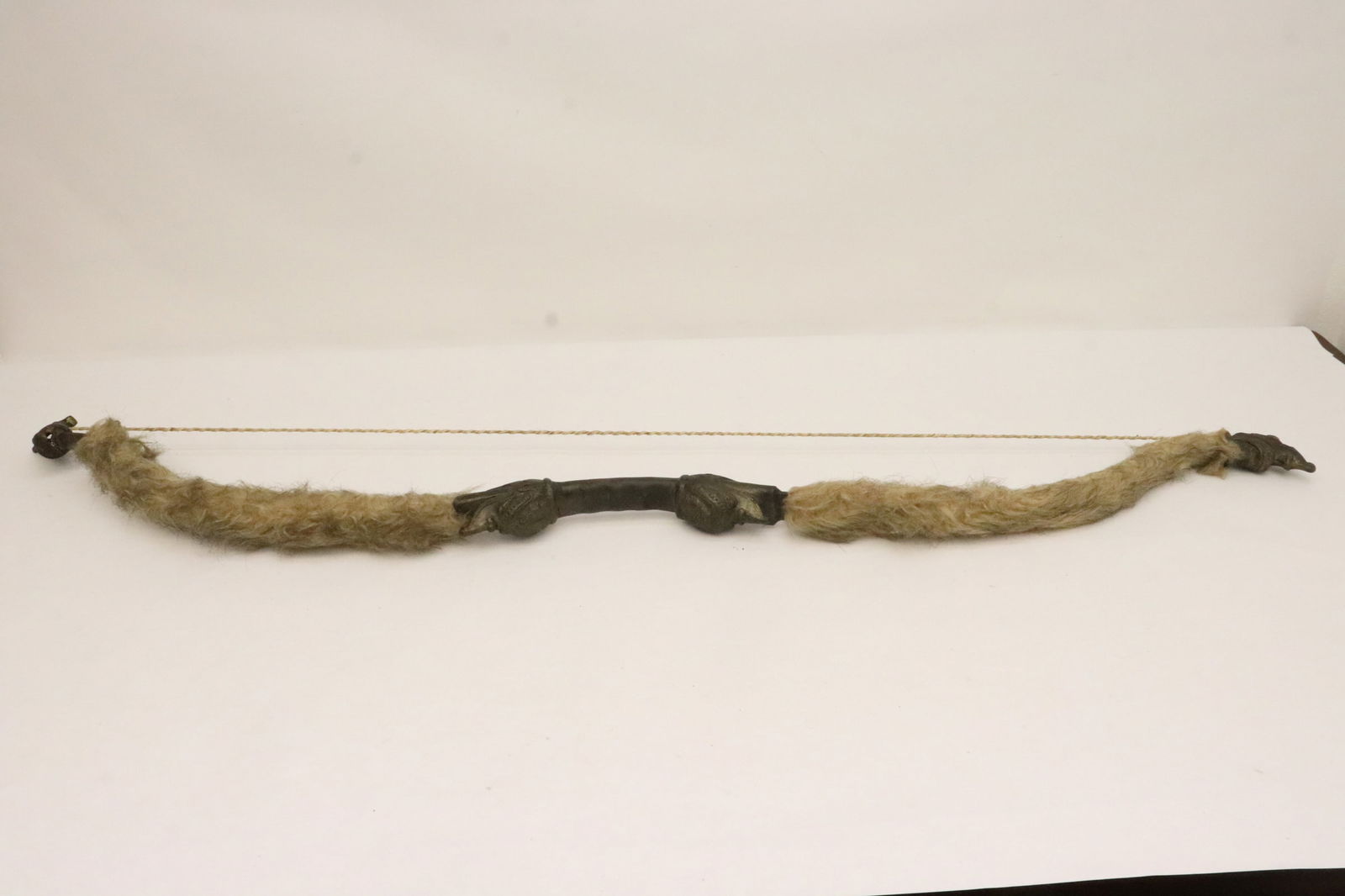 A rare Chinese cast metal bow: A rare Chinese cast metal bow with dragon/ qilin motif decoration, and with calligraphy, 48.2"L