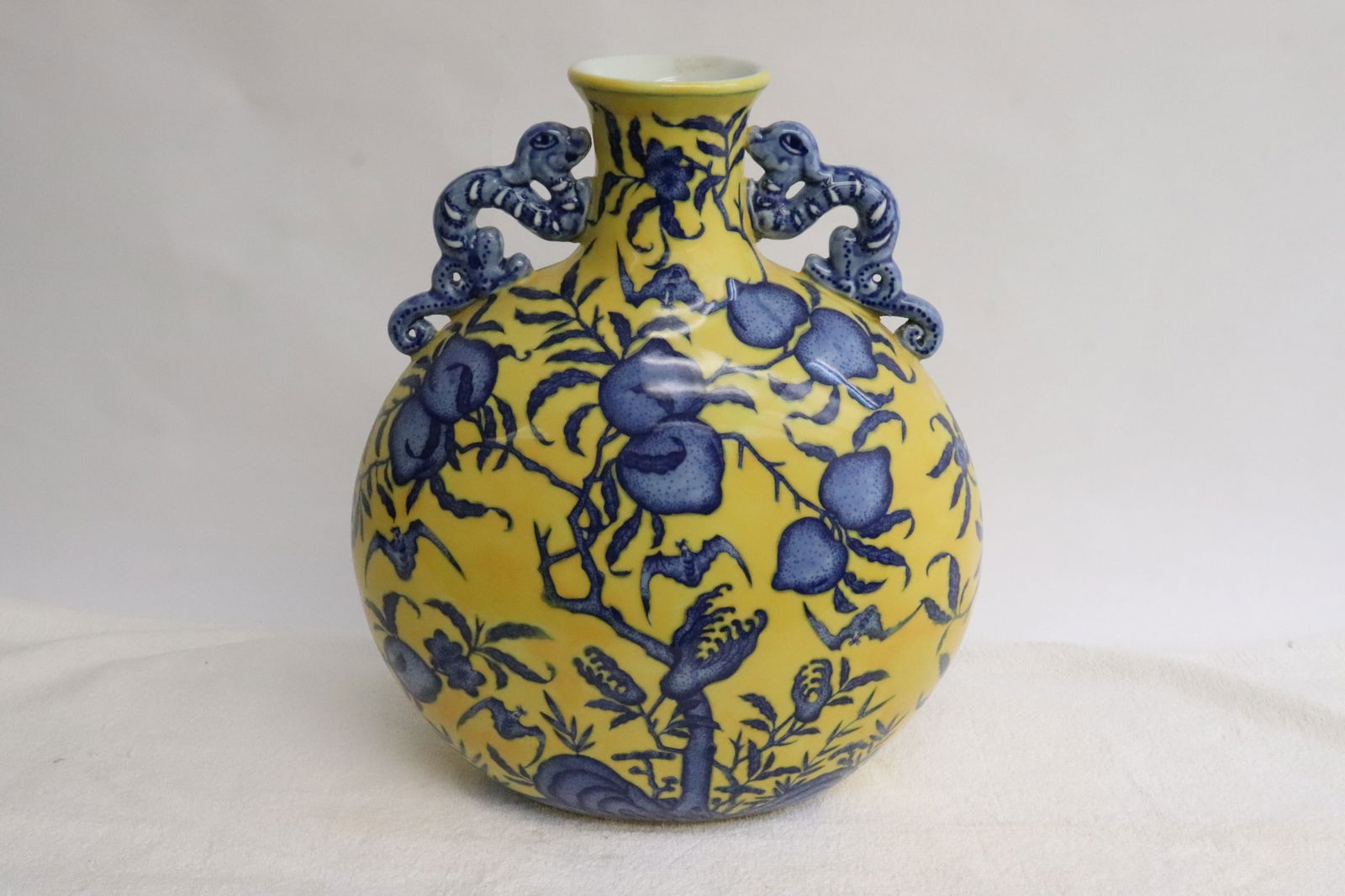 A blue on yellow porcelain flask: A blue on yellow porcelain flask, 11.9"x10"x6.3"