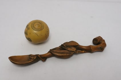 2 pieces; a incised ball, and a wood like ornament