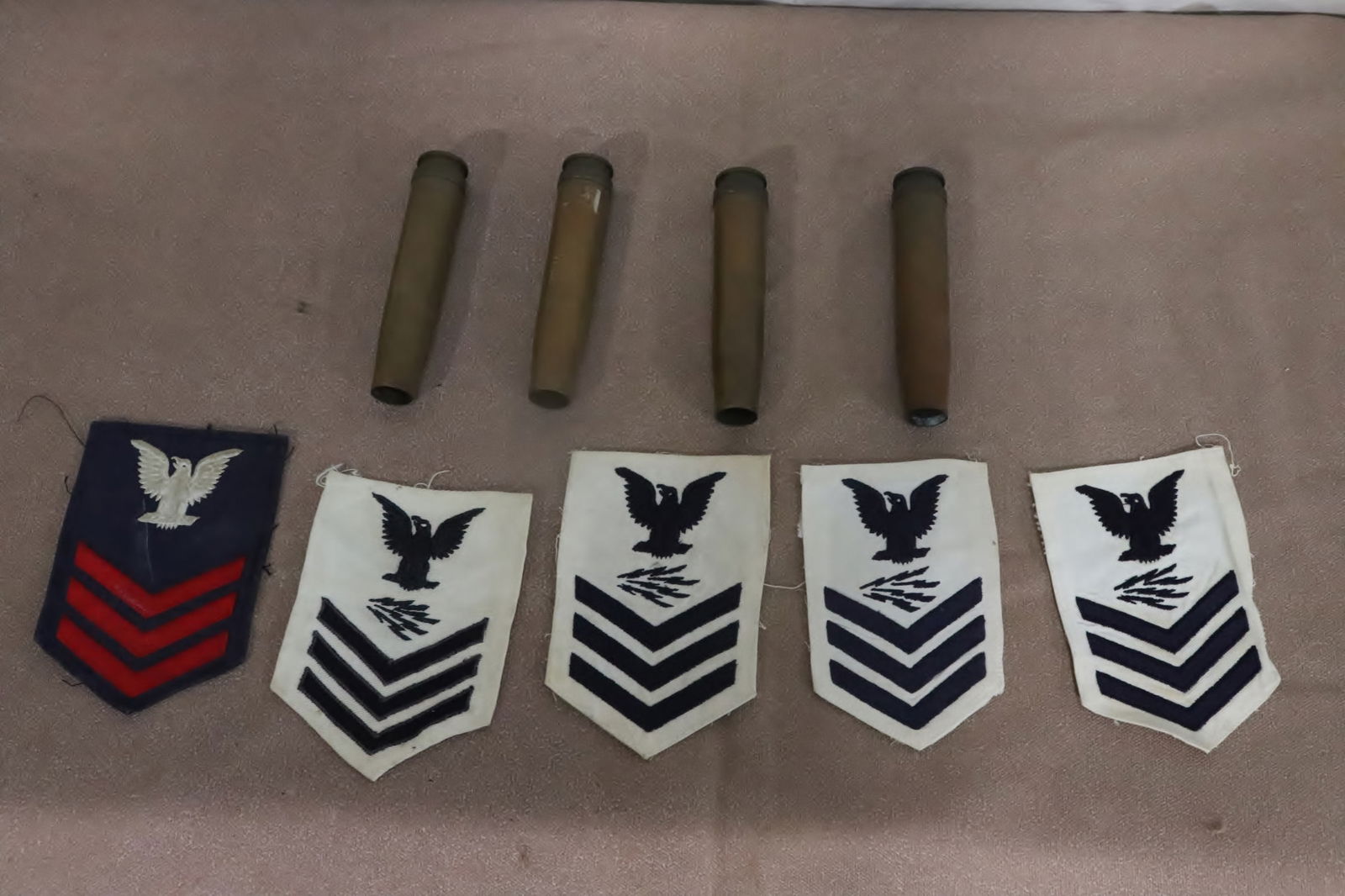 5 WWII military patches, and 4 WWII gun shells: 5 WWII military patches (5.65"x4" - 5.7"x3.85"), and 4 WWII gun shells (5.35"x1.2"dia ea)