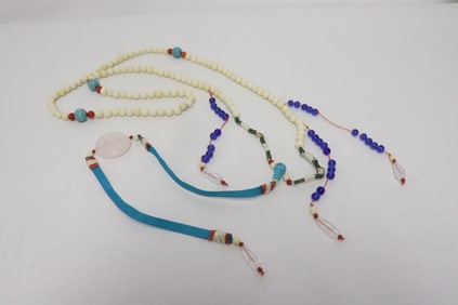 A long necklace with bone like beads