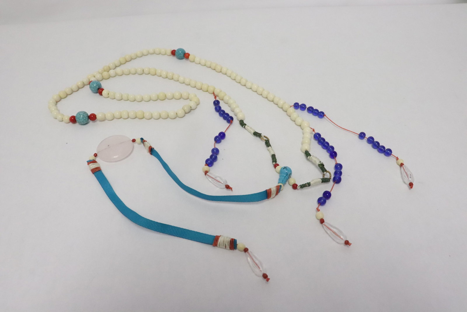 A long necklace with bone like beads: A long necklace (41""L) with bone like beads (0.3"x0.3"dia ea)