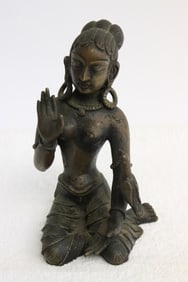 A South Asian bronze sculpture of seated deity