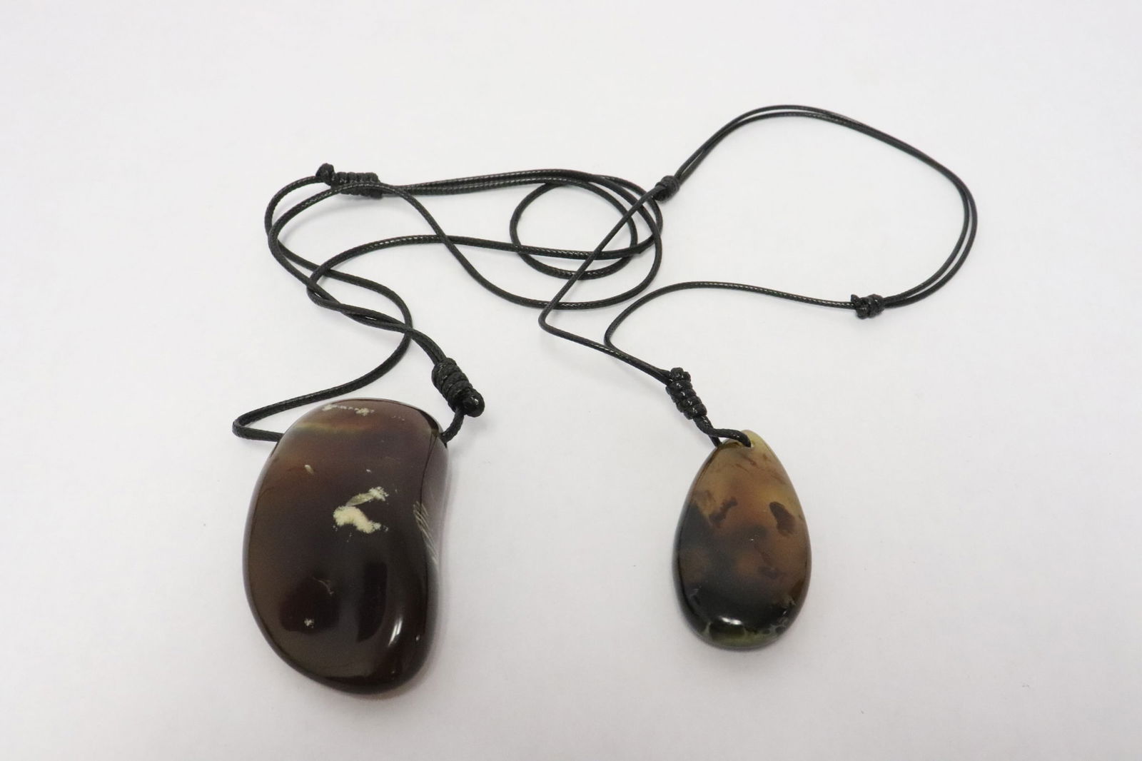 2 amber pendants: 2 amber pendants, 2.25"x1.2"x0.5", 2.85"x1.8"x0.95"