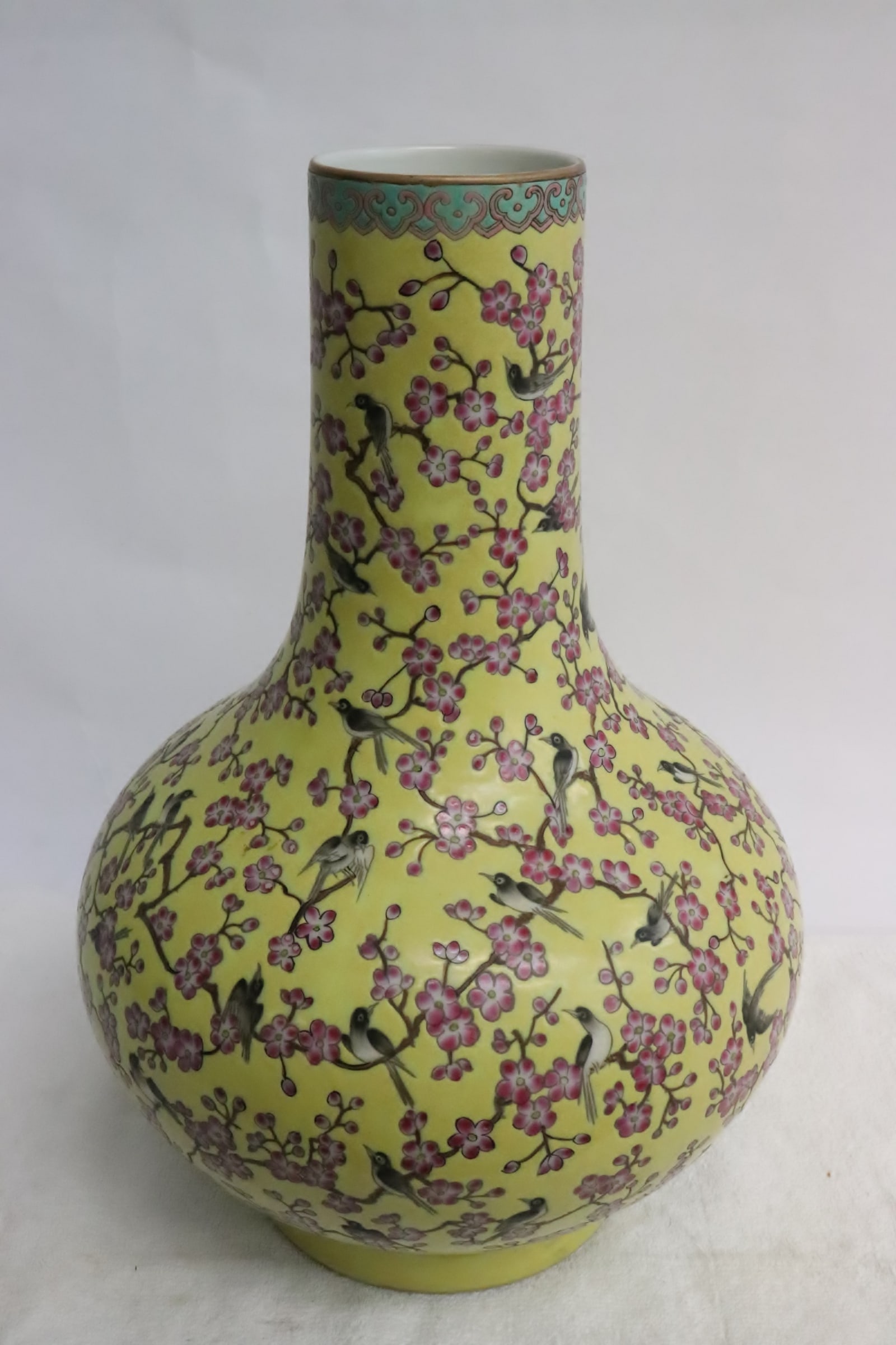 A yellow background famille rose porcelain bottle vase: A yellow background famille rose porcelain bottle vase, 12.65"x8.75"dia