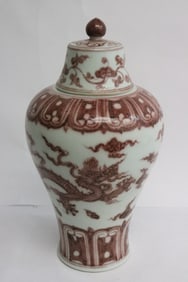A red and white porcelain covered jar