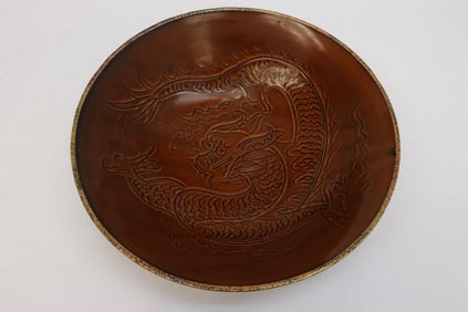 Large brown glazed bowl with embossed decoration