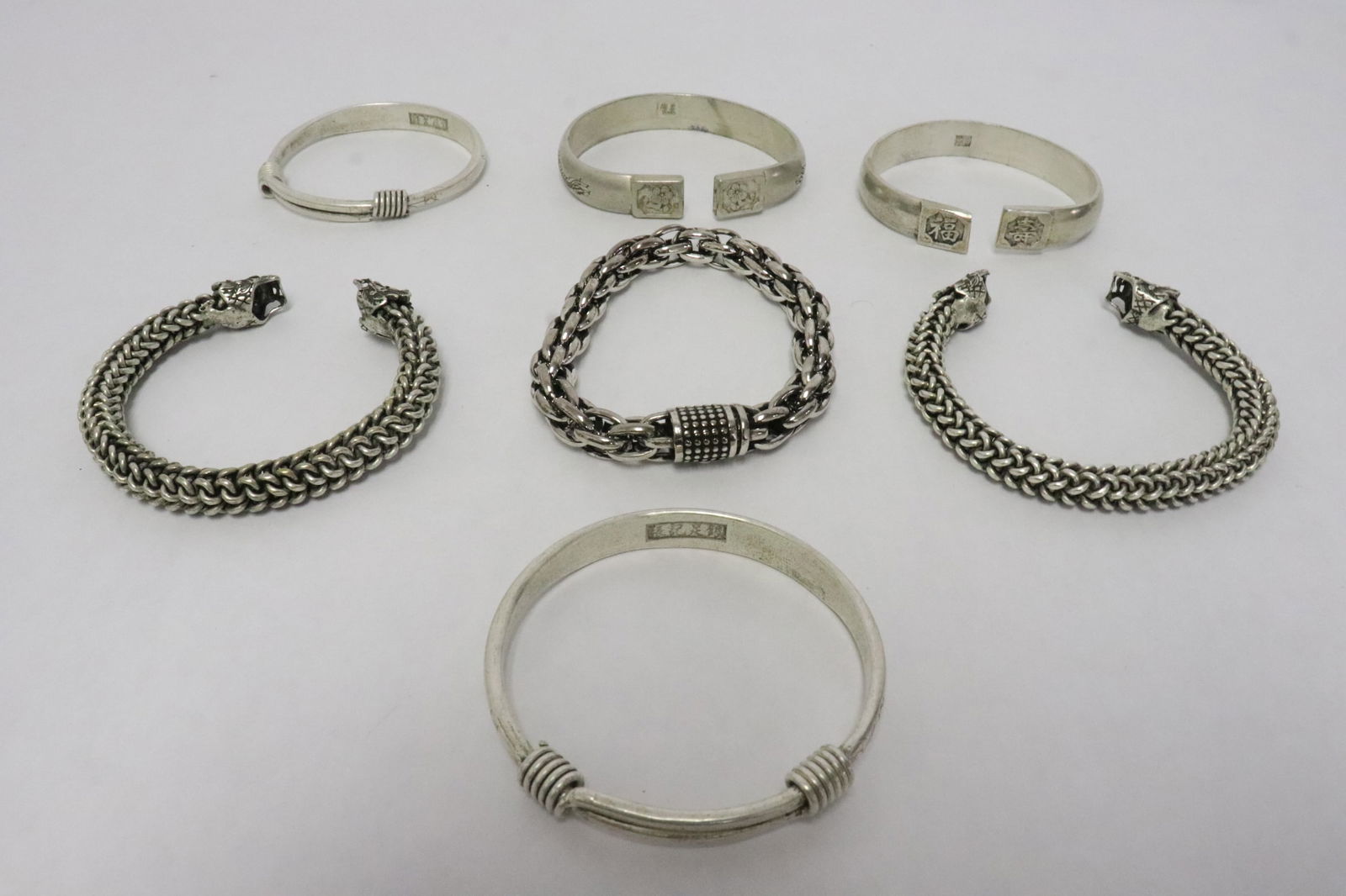 7 white metal bracelets: 7 white metal bracelets, 0.35"x2.8"dia - 0.5"x3.35"dia