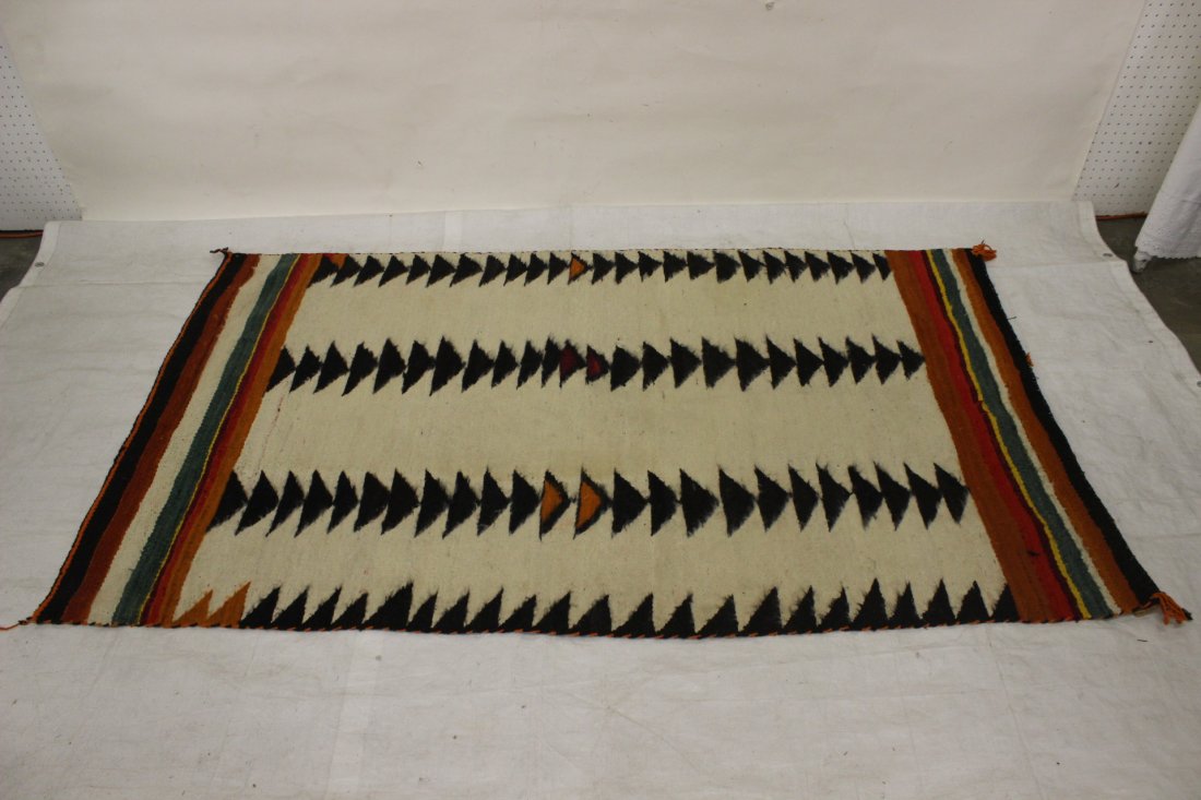 A large American Navajo rug: A large American Navajo rug (light stain), circa 1920. Provenance: Estate of Jesse Bird Ellis. 76.5"x47"
