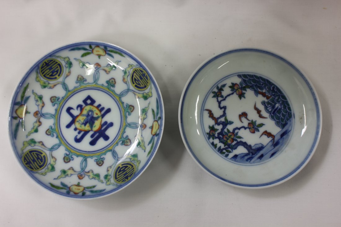 2 Chinese Famille Rose small porcelain plates: 2 Chinese Famille Rose small porcelain plates, one painted with bats and fruits (1.4"Hx4.5"dia), one decorated with symbol of longevity (1.15"Hx5"dia)