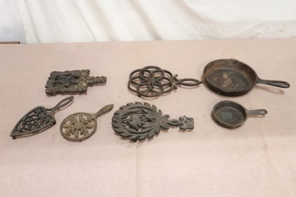 5 cast iron trivet, and 2 cast iron frying pans