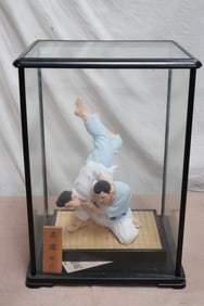 A large Hamada figure of wrestler in display case