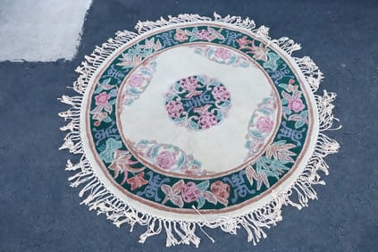 A round Chinese wool area rug