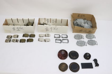 Box of belt buckles, and few wood stands