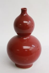 A red glazed porcelain gourd shape vase