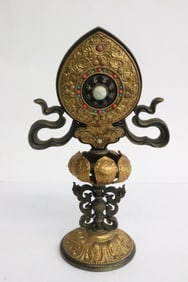 A gilt metal religious ornament with jewels